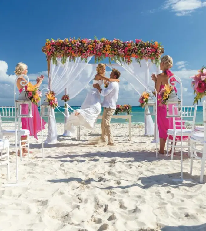 Beach ceremony with the groom lifting the bride at Riu Palace Riviera Maya, Playa Del Carmen
