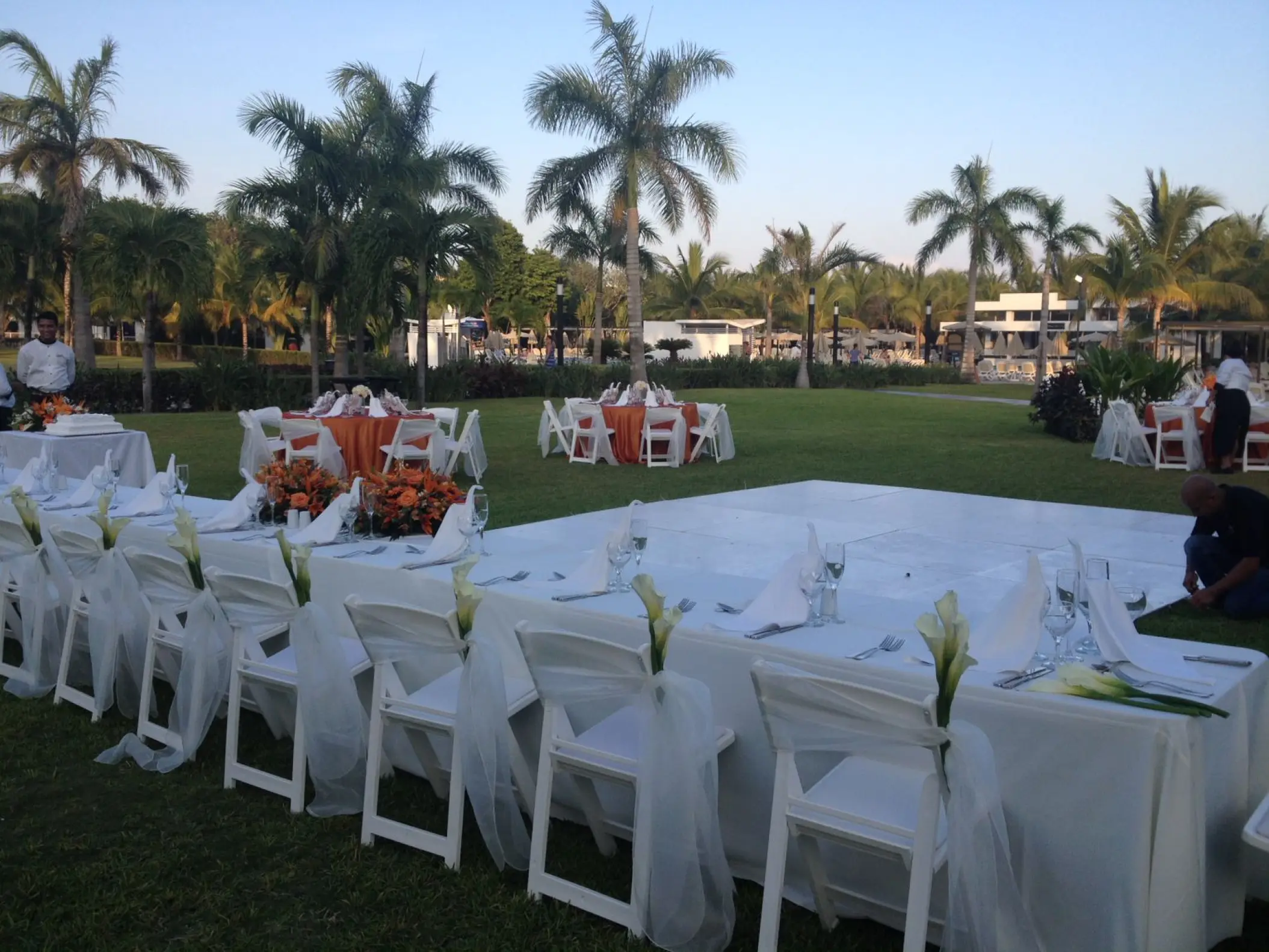 Outdoor wedding reception setup with white linens and a dance floor at Riu Palace Costa Mujeres, Cancun