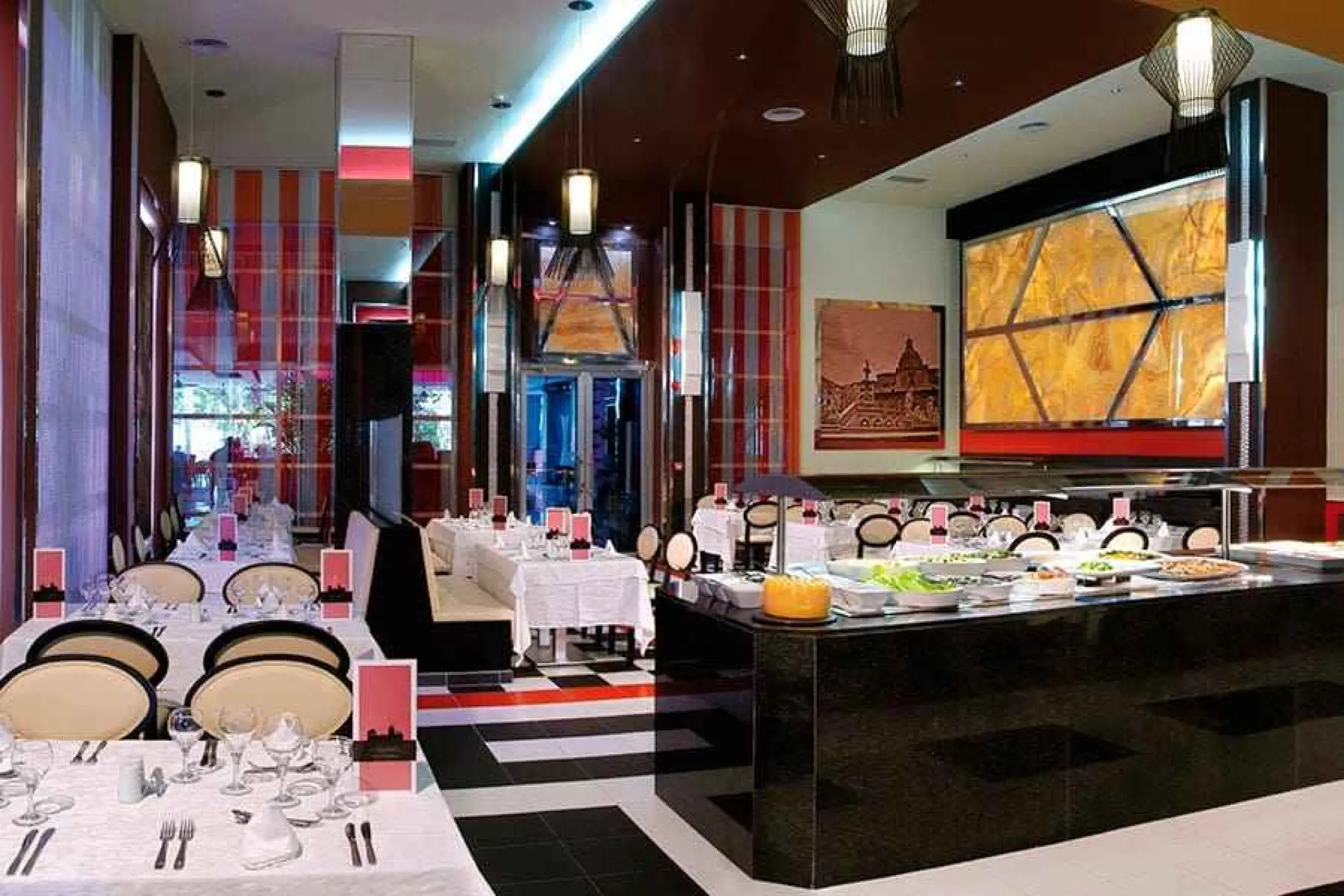 Italian buffet restaurant with white tablecloths and modern lighting at Riu Yucatan, Playa Del Carmen