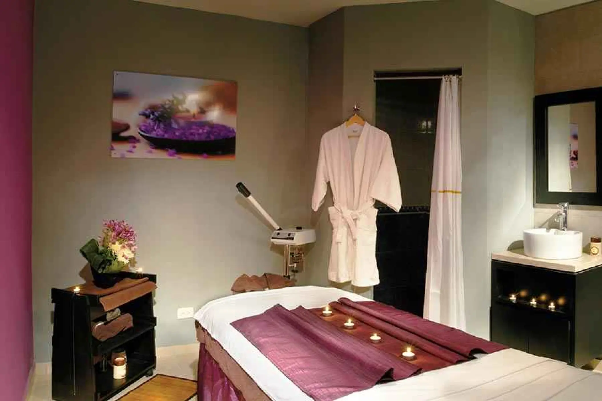 Massage table with purple runners and candles at the Riu Yucatan spa, Playa Del Carmen