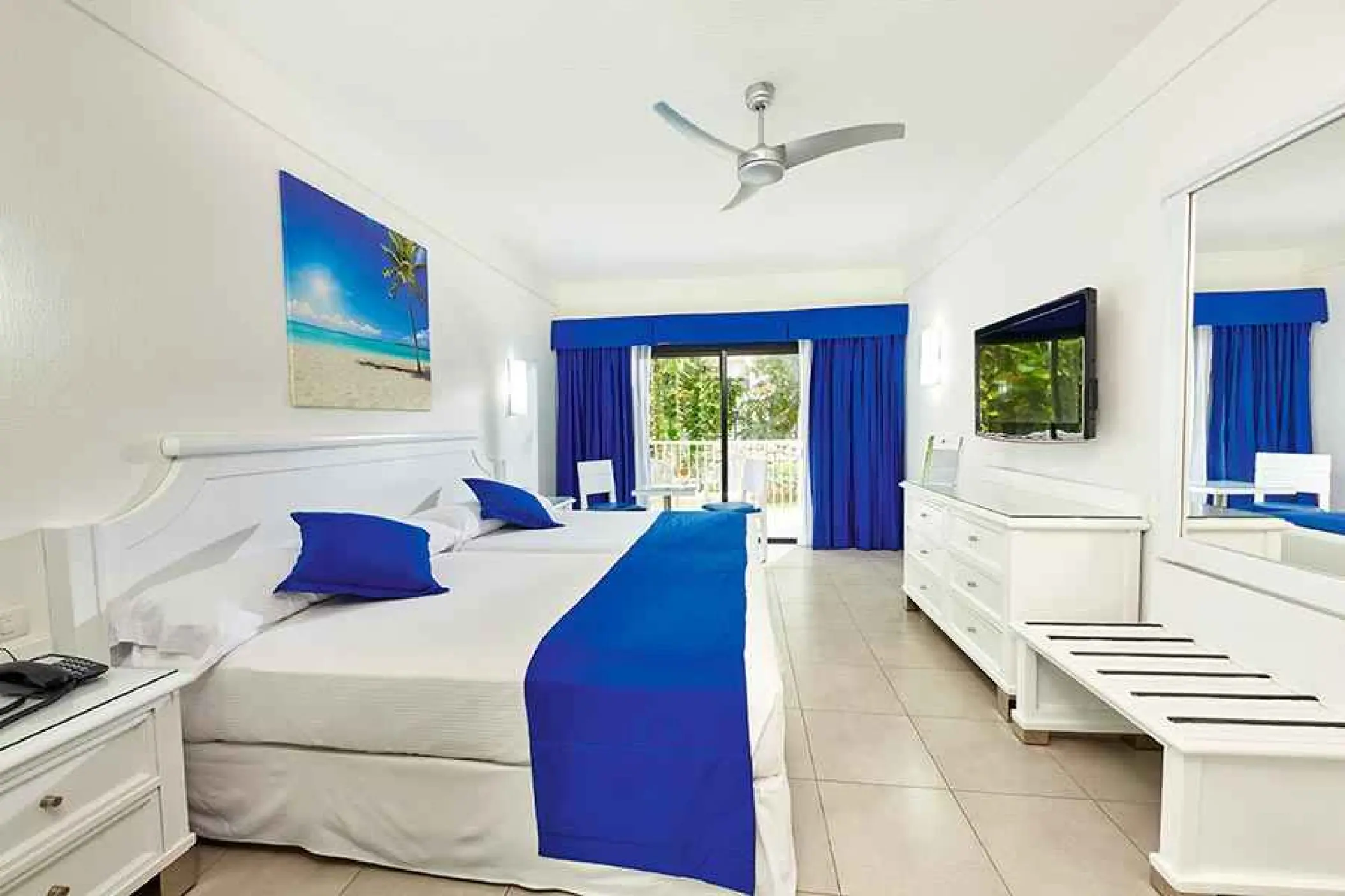 Standard room with blue accents and balcony at Riu Yucatan, Playa Del Carmen