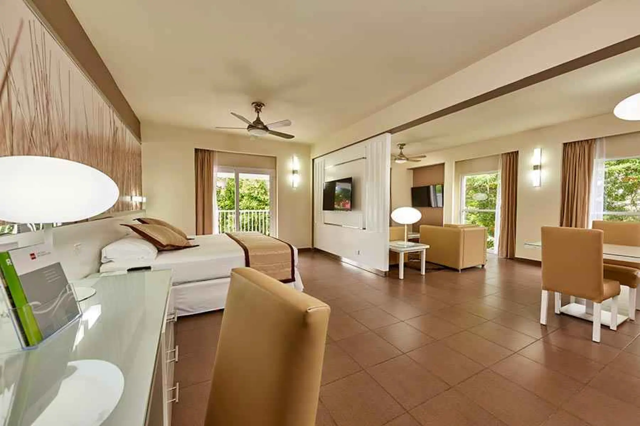 Modern hotel suite with sitting area and balcony at Riu Yucatan, Playa Del Carmen