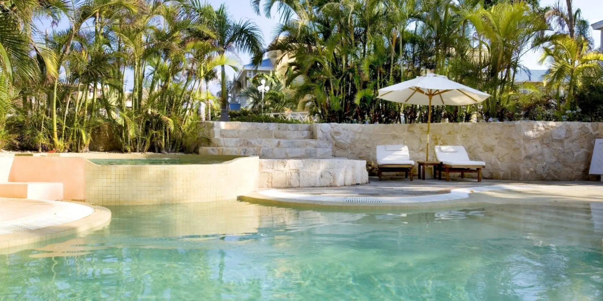 Royal Hideaway Playacar swimming pool with loungers and palm trees, Playa Del Carmen