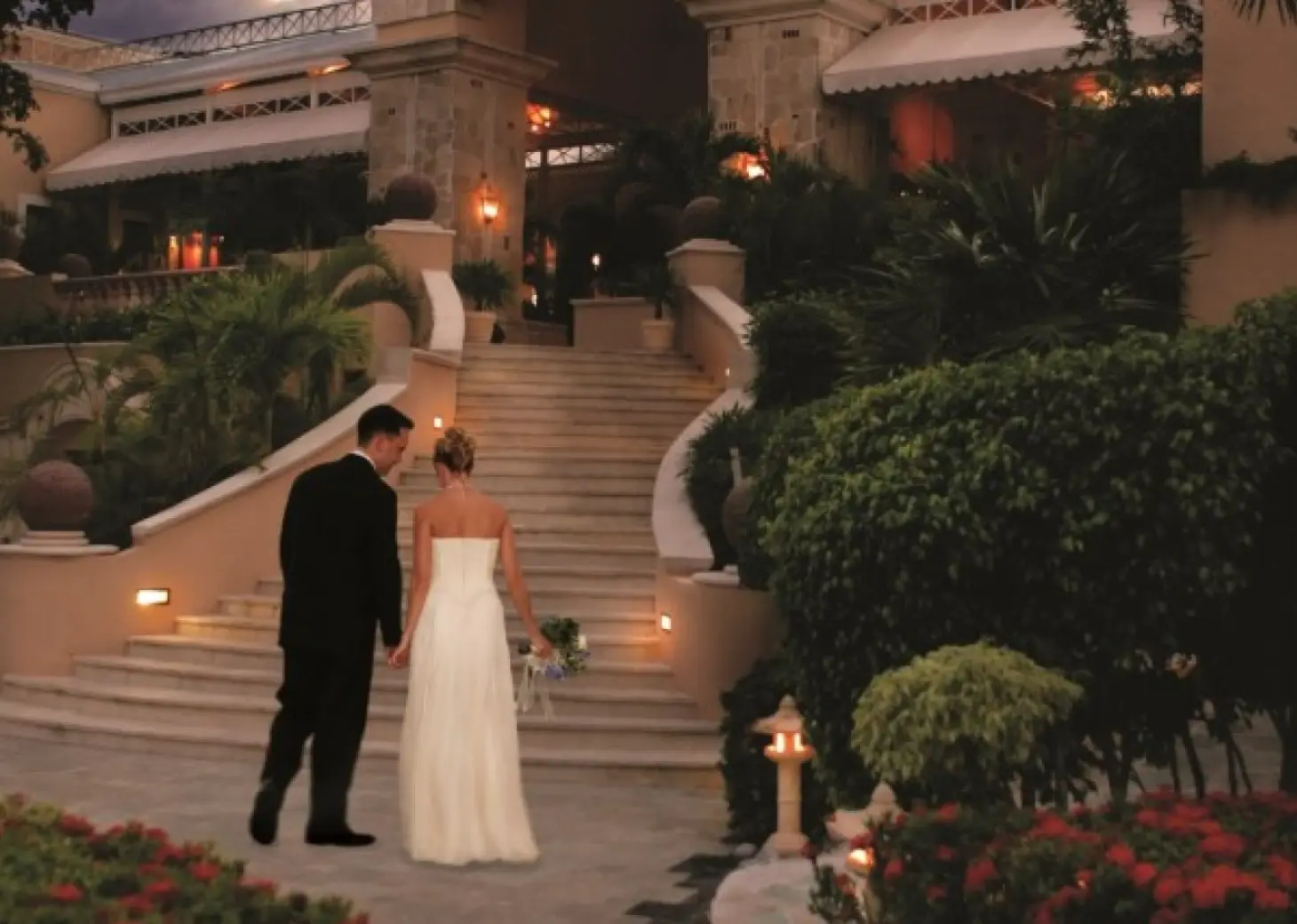 Royal Hideaway Playacar adults-only stairs with bride and groom