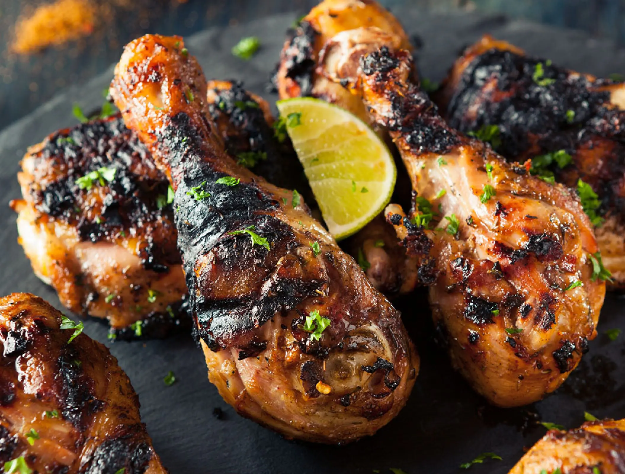 Grilled jerk chicken drumsticks with lime at Royalton Blue Waters, Montego Bay