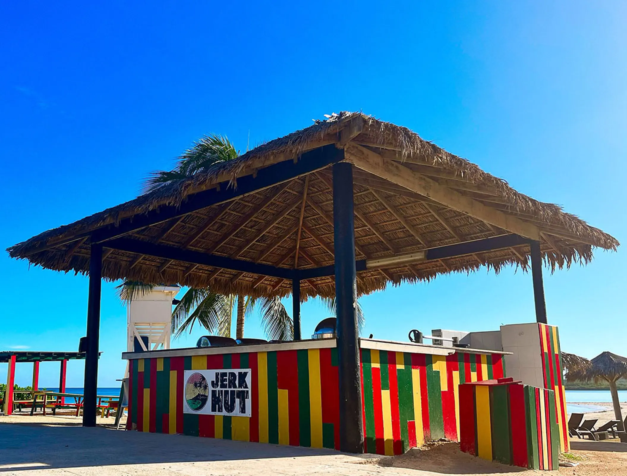 Jerk Hut snack bar with a thatched roof at Royalton Blue Waters, Montego Bay