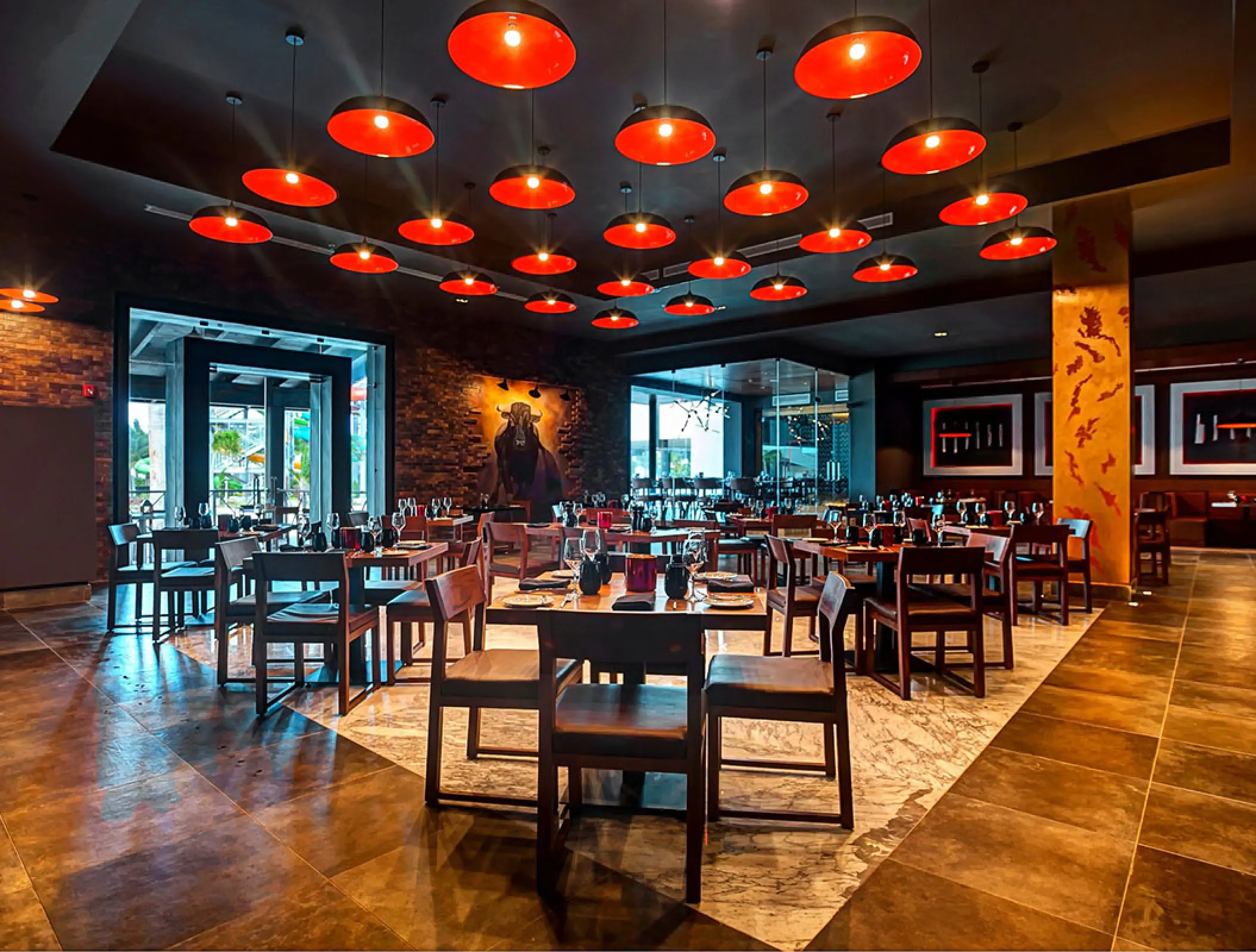 Steakhouse dining room with red pendant lights at Royalton Blue Waters, Montego Bay