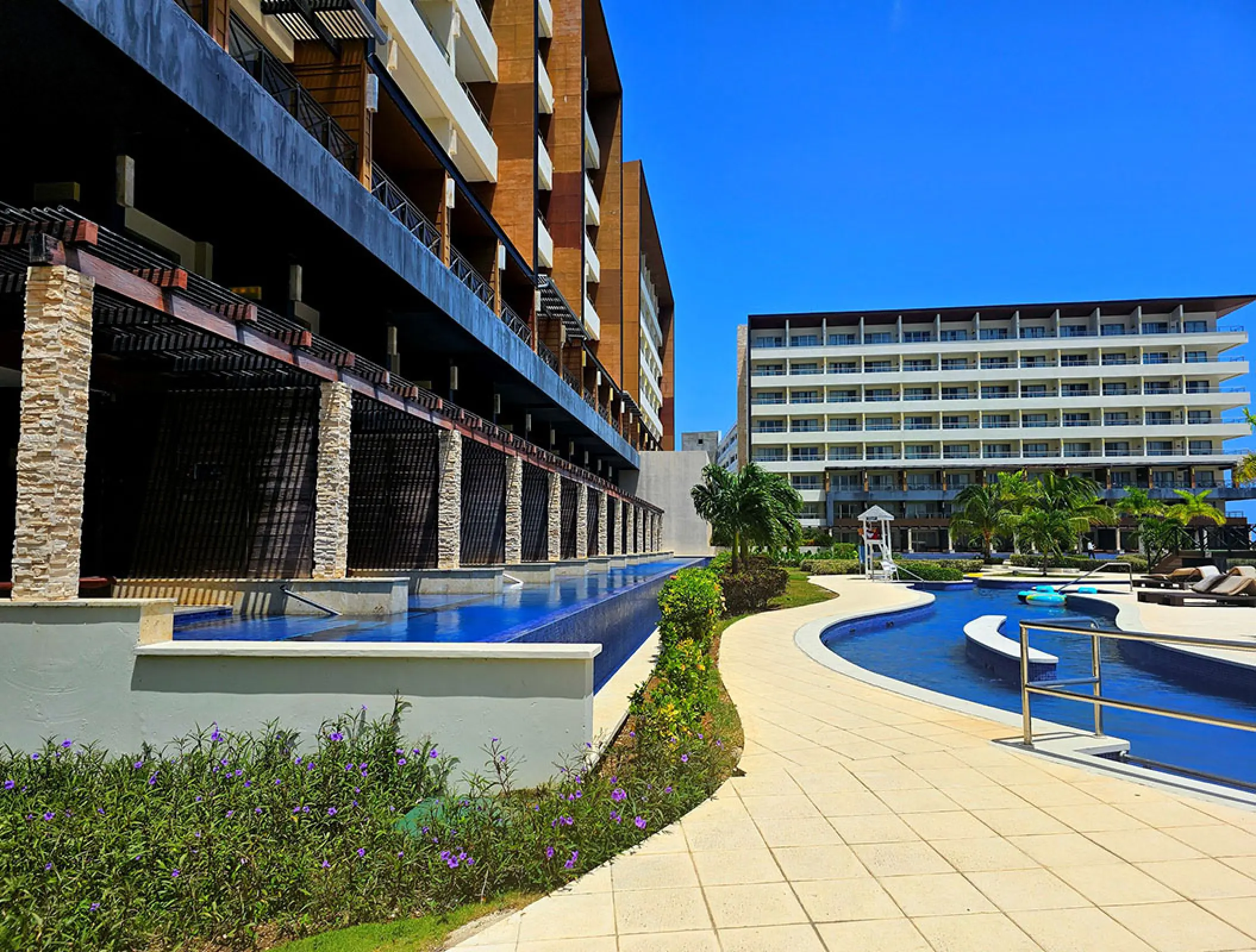 Royalton Blue Waters modern building exterior and lazy river pool, Montego Bay