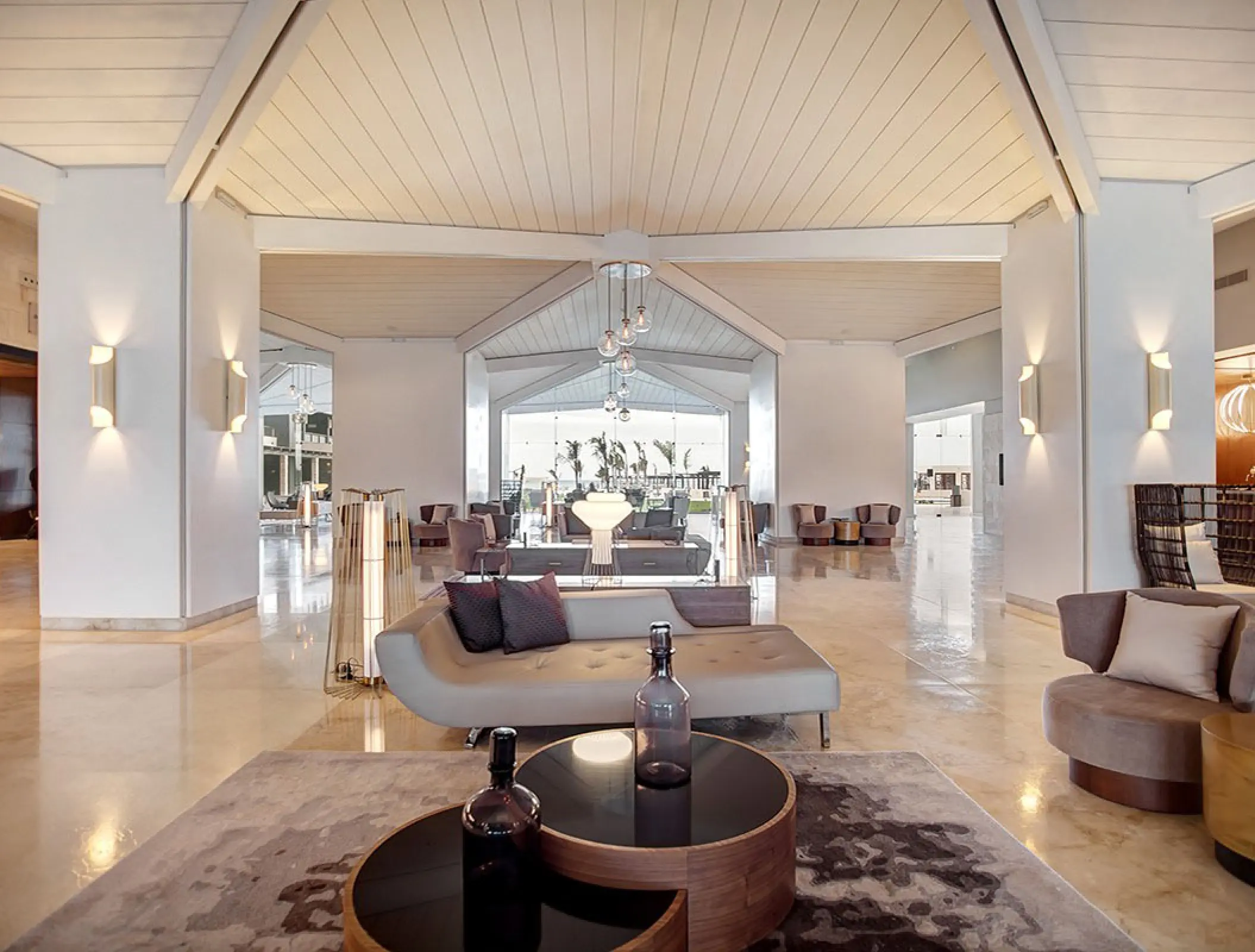 Modern open-air lobby with neutral-toned seating at Royalton Blue Waters, Montego Bay