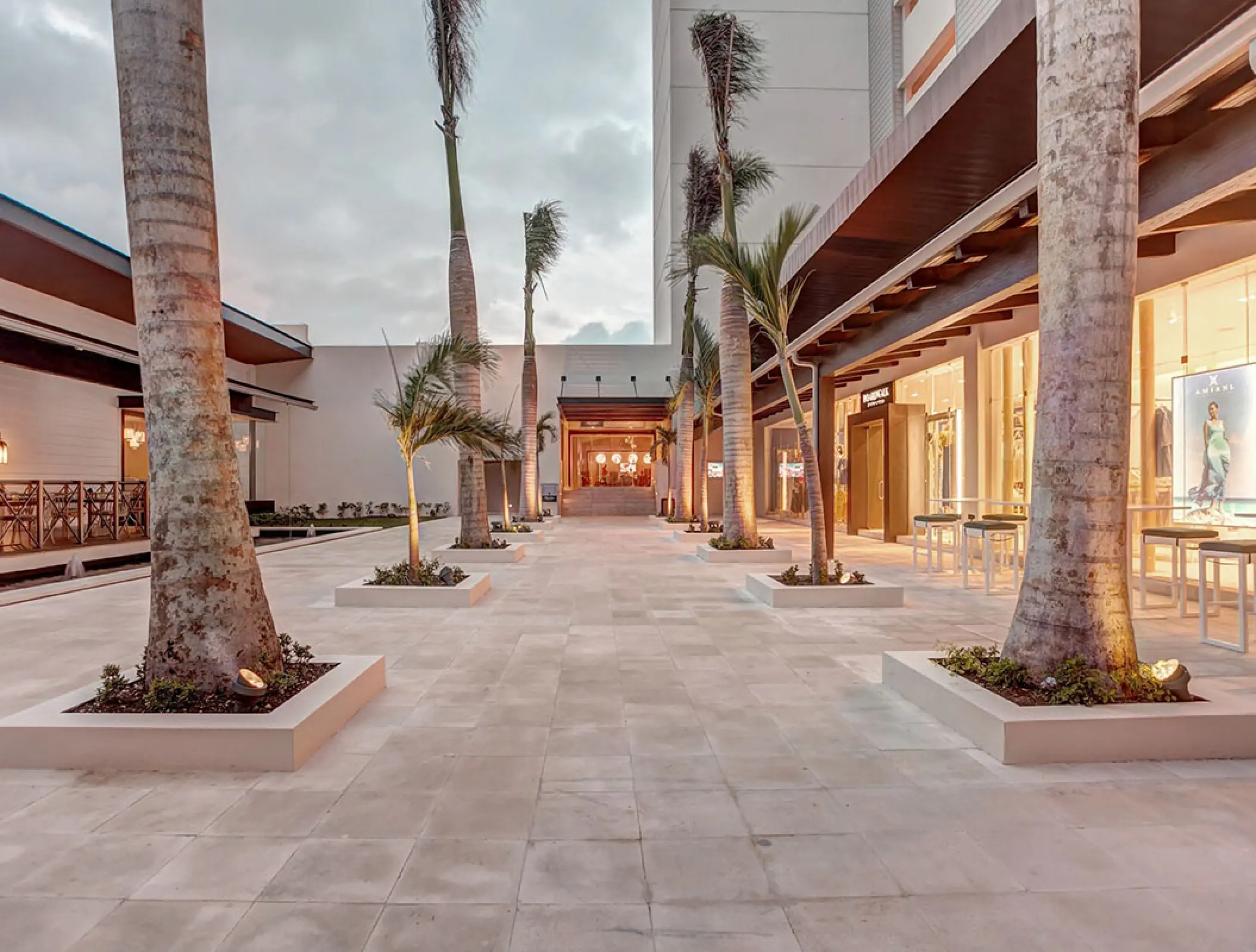 Outdoor shopping promenade with palm trees at Royalton Blue Waters, Montego Bay