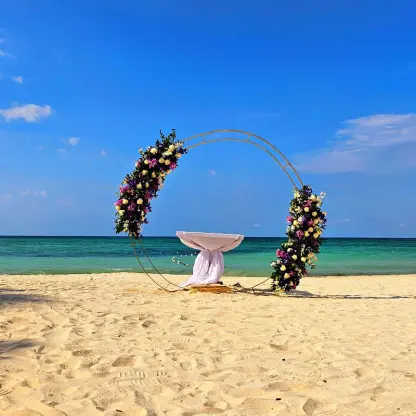 Circular floral wedding ceremony arch on the beach at Royalton Blue Waters, Montego Bay