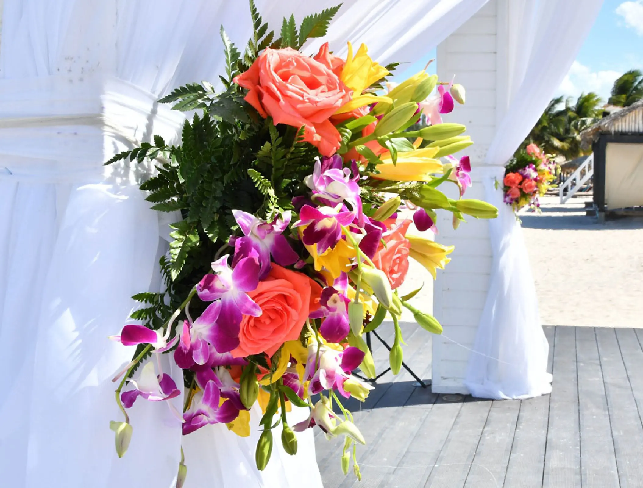 Colorful floral arrangement on a white wedding gazebo at Royalton Blue Waters, Montego Bay