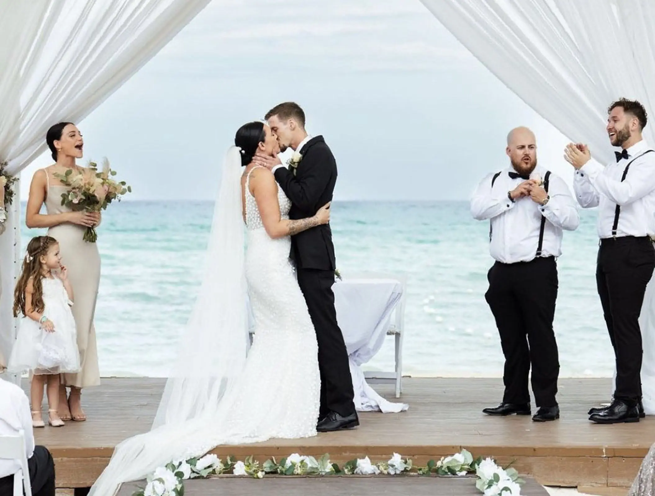 Bride and groom kissing during their beach ceremony at Royalton Blue Waters, Montego Bay
