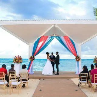 Beachfront wedding ceremony under a gazebo with turquoise drapes at Royalton Blue Waters, Montego Bay