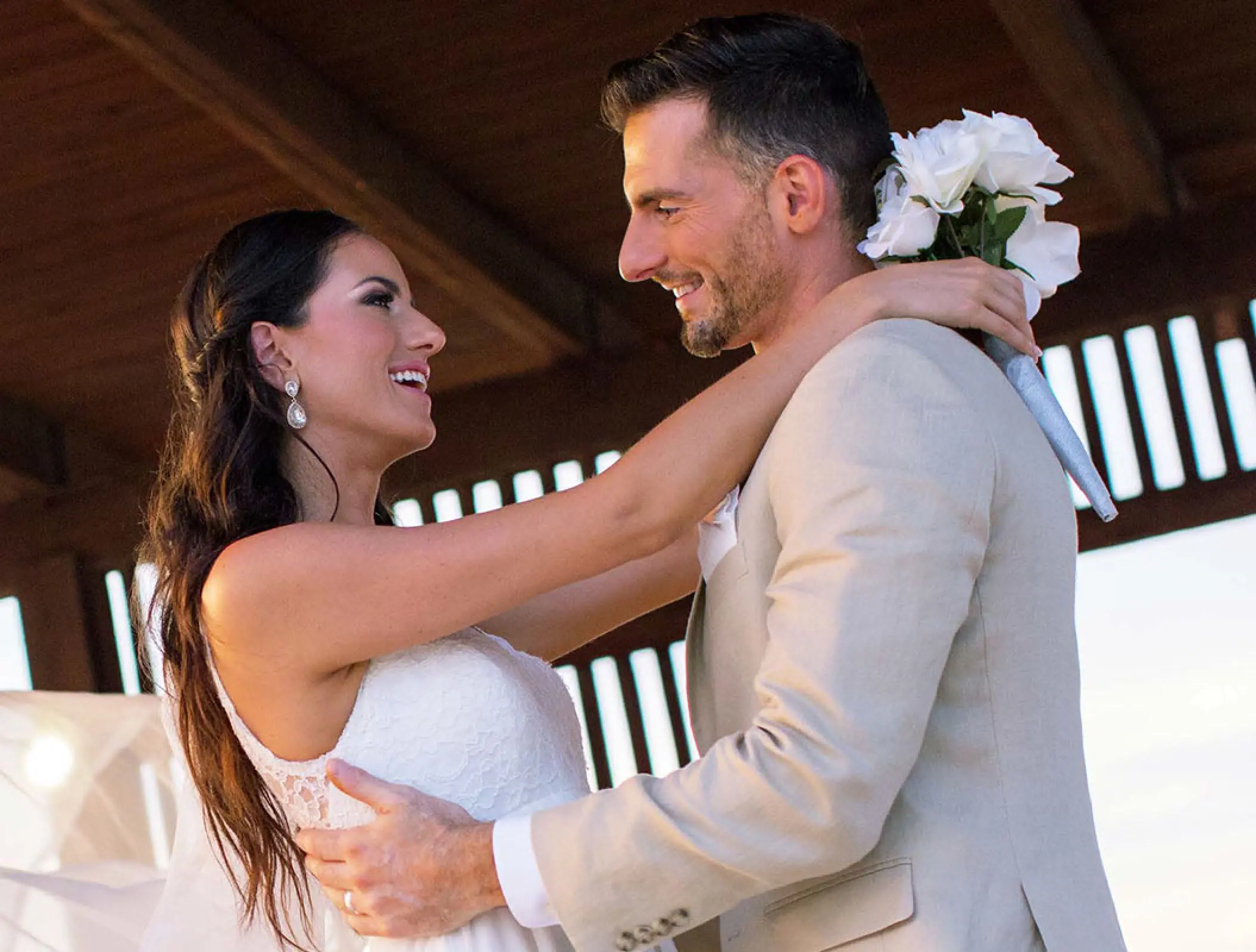 Newlyweds smiling at each other during a wedding ceremony at Royalton Blue Waters, Montego Bay