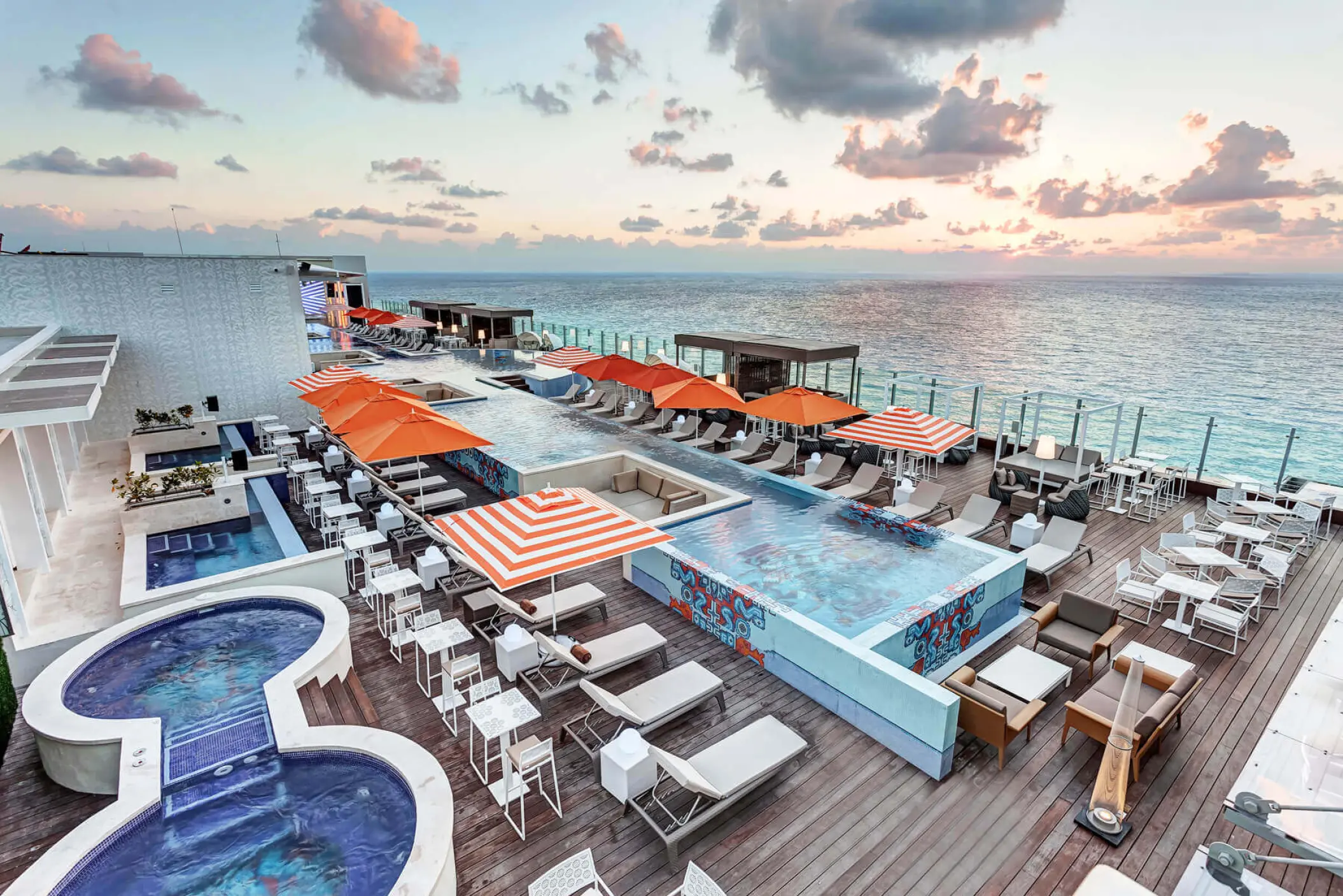 Aerial view of the rooftop pool and lounge area at Royalton CHIC Cancun