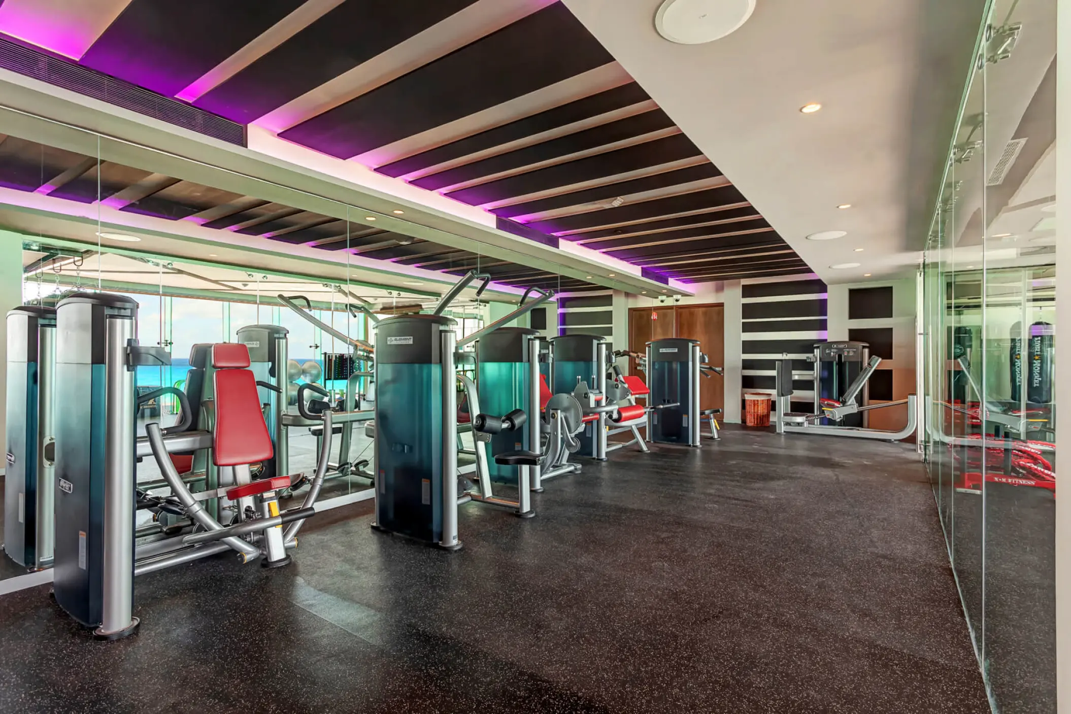 Modern fitness center with weight machines at Royalton CHIC Cancun