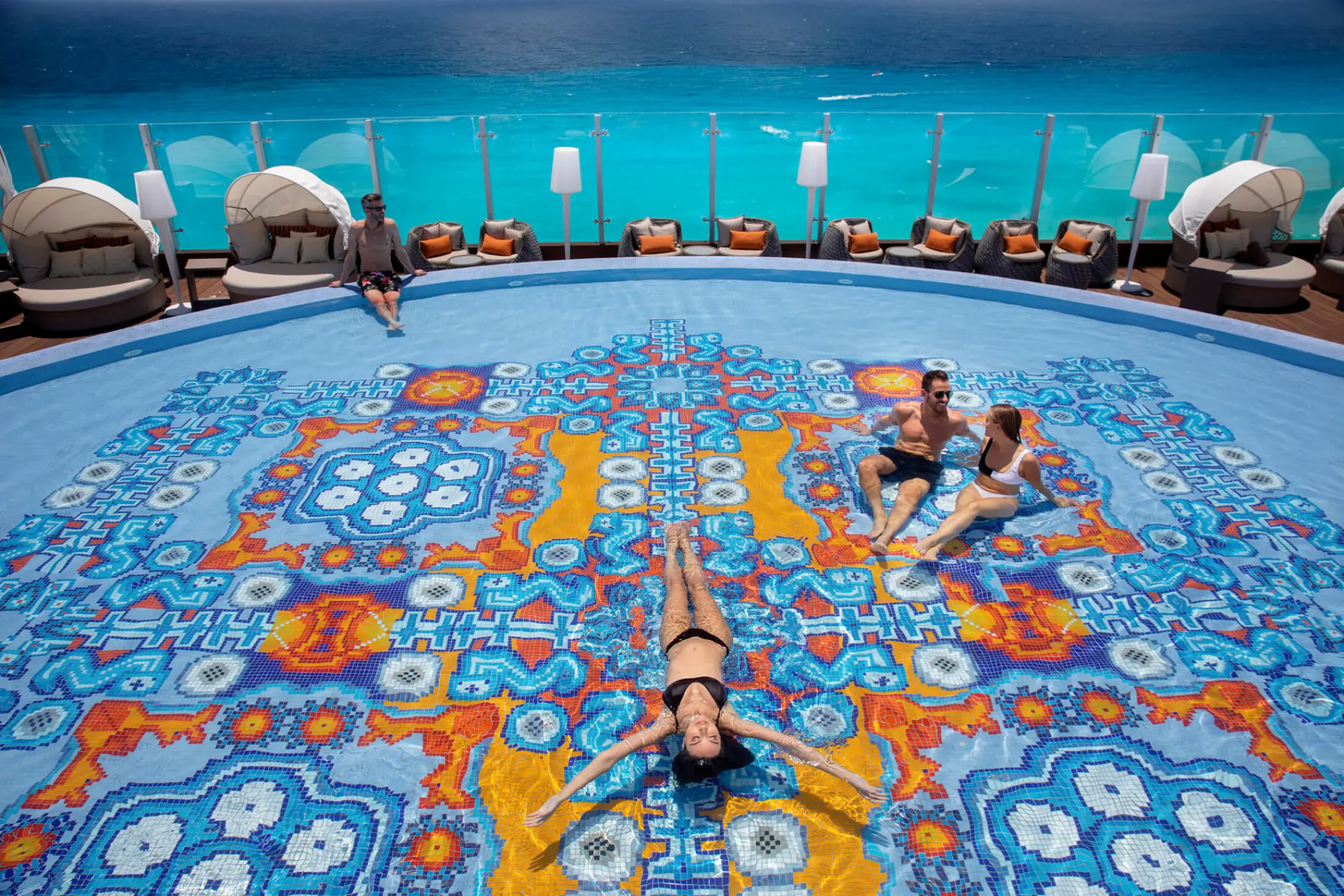 Colorful mosaic infinity pool overlooking the ocean at Royalton CHIC Cancun, Cancun