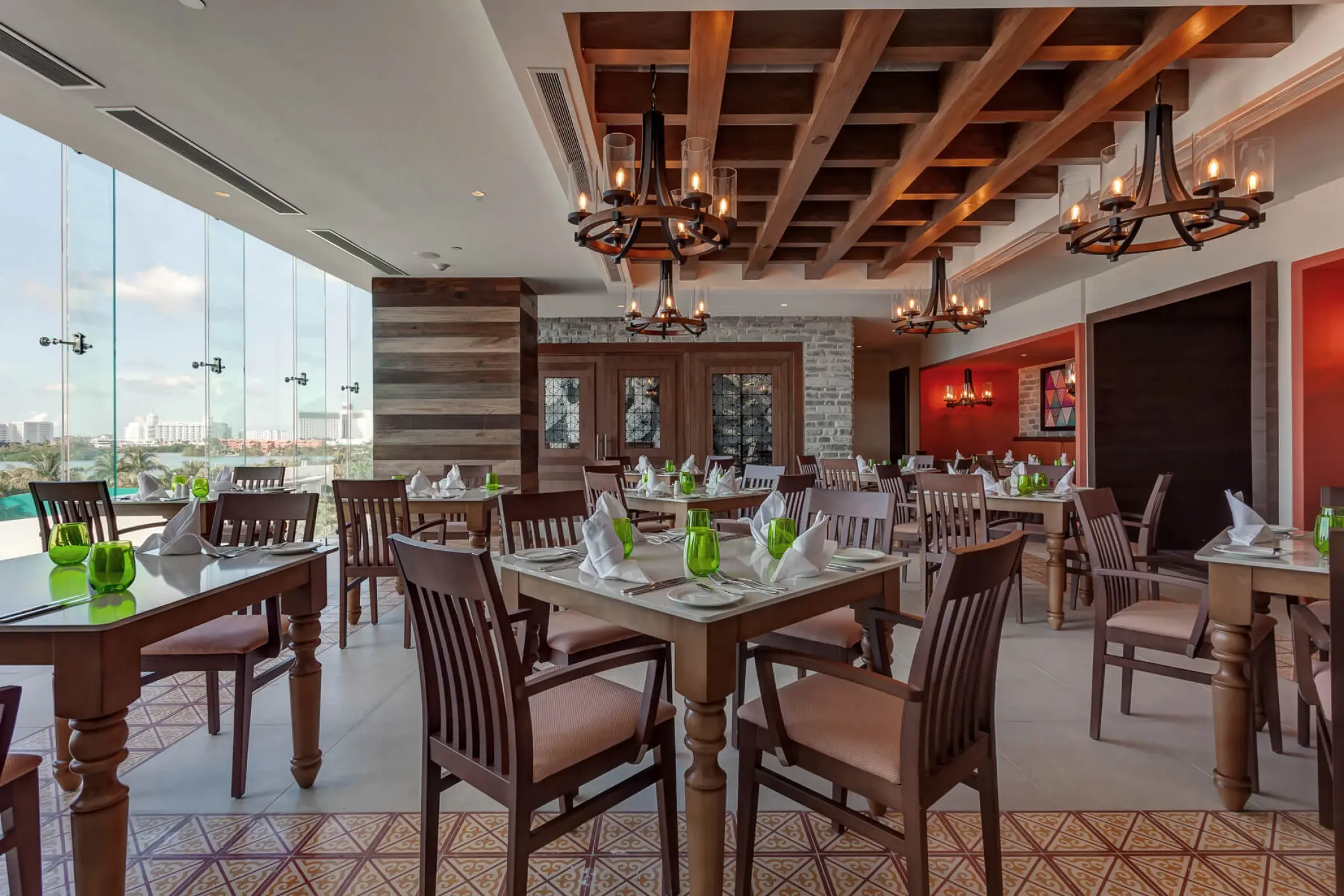 Indoor restaurant dining area with large windows at Royalton CHIC Cancun, Cancun