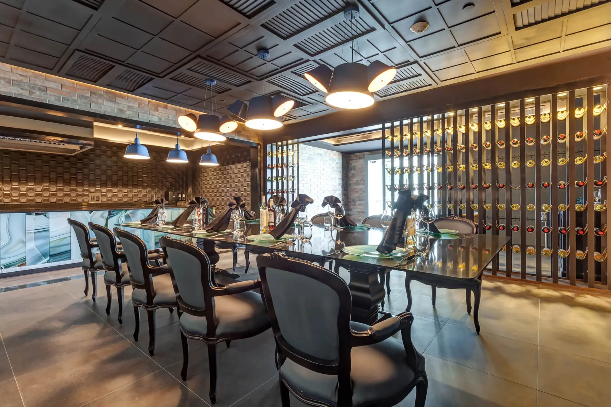 Private dining table with elegant seating and modern light fixtures at Royalton CHIC Cancun