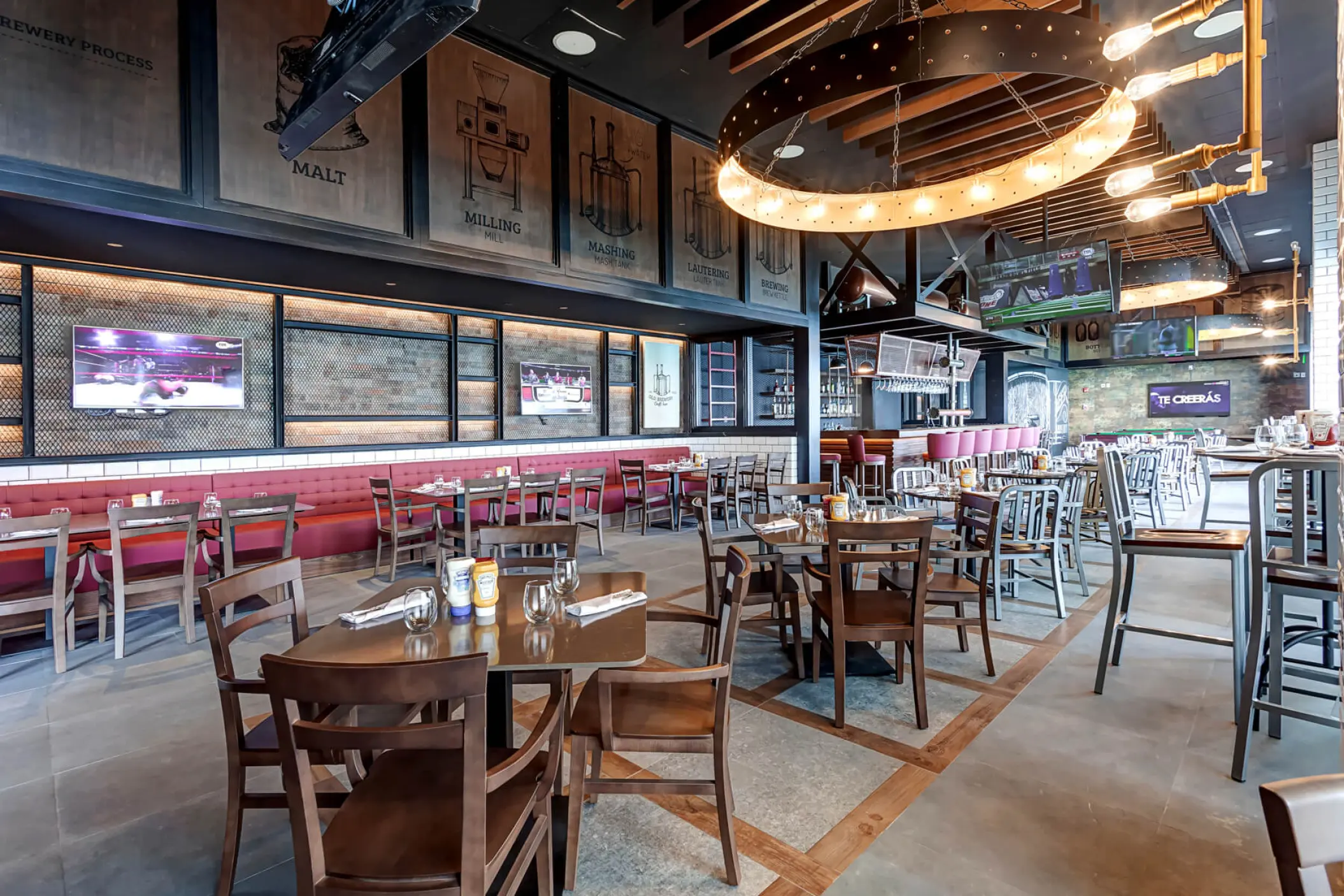 Modern restaurant interior with circular light fixtures at Royalton CHIC Cancun
