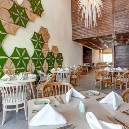Modern restaurant interior with geometric wall art at Royalton CHIC Cancun