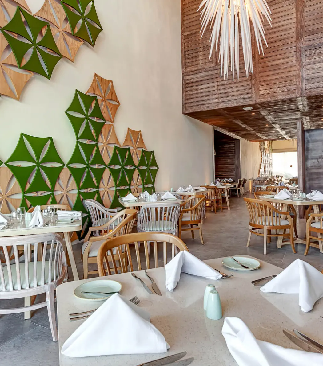 Modern restaurant interior with geometric wall art at Royalton CHIC Cancun