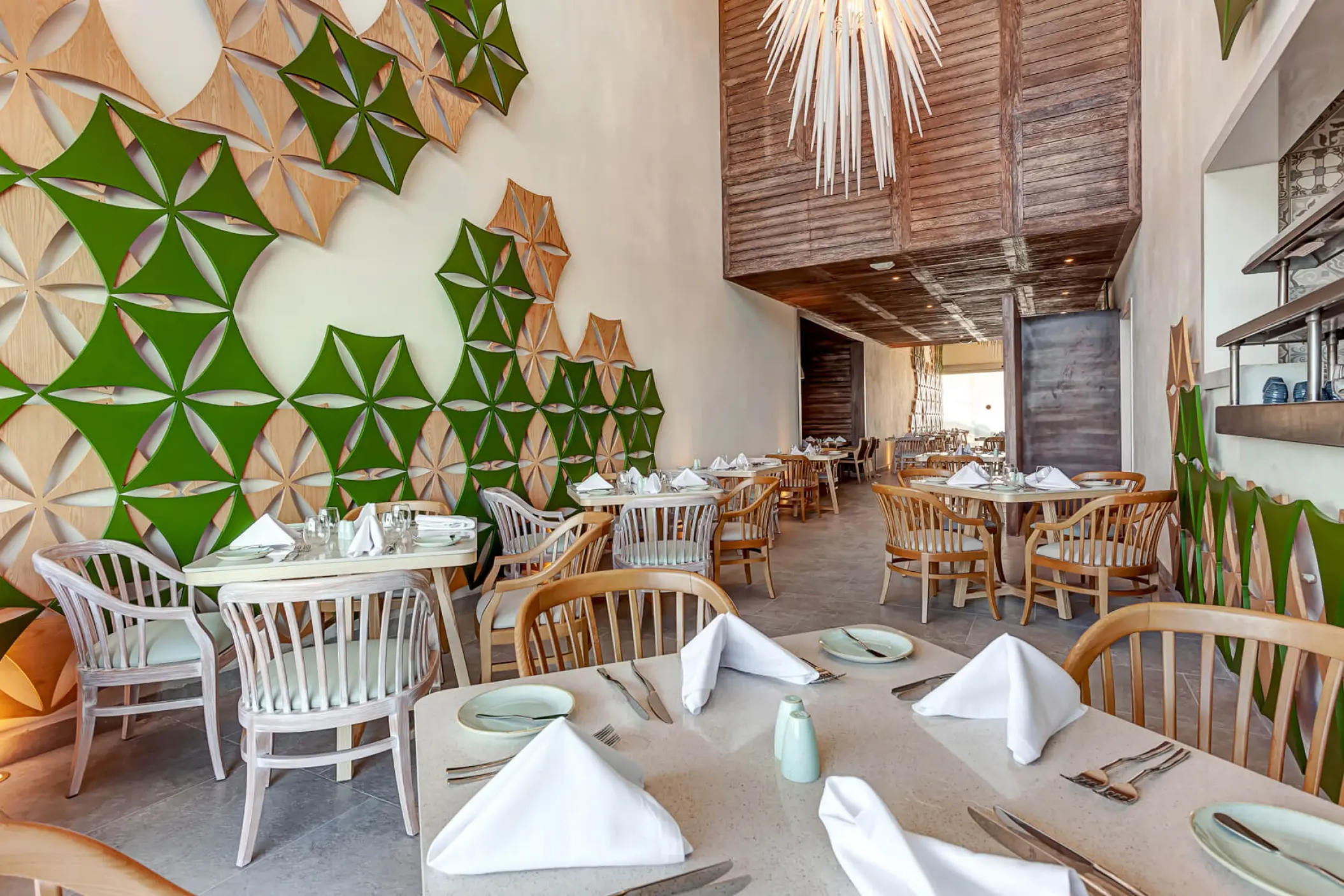 Modern restaurant interior with geometric wall art at Royalton CHIC Cancun