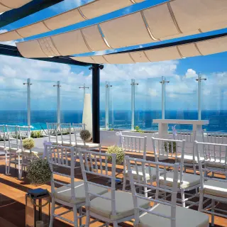 Sky terrace wedding ceremony with white chairs and ocean views at Royalton CHIC Cancun, Cancun