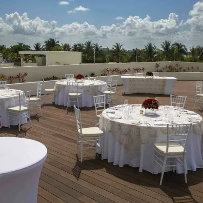 Outdoor wedding reception setup on the Sunset Terrace at Royalton CHIC Cancun