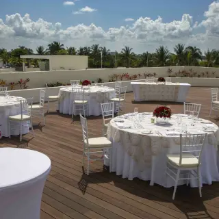 Outdoor wedding reception setup on the Sunset Terrace at Royalton CHIC Cancun