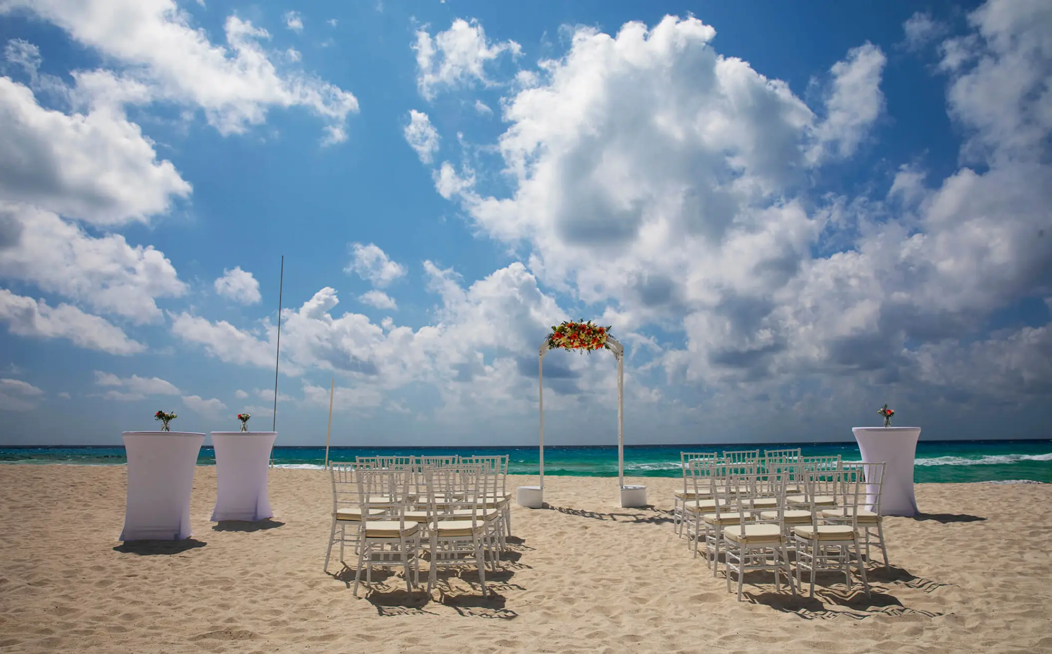 Beachfront wedding ceremony setup at Royalton CHIC Cancun