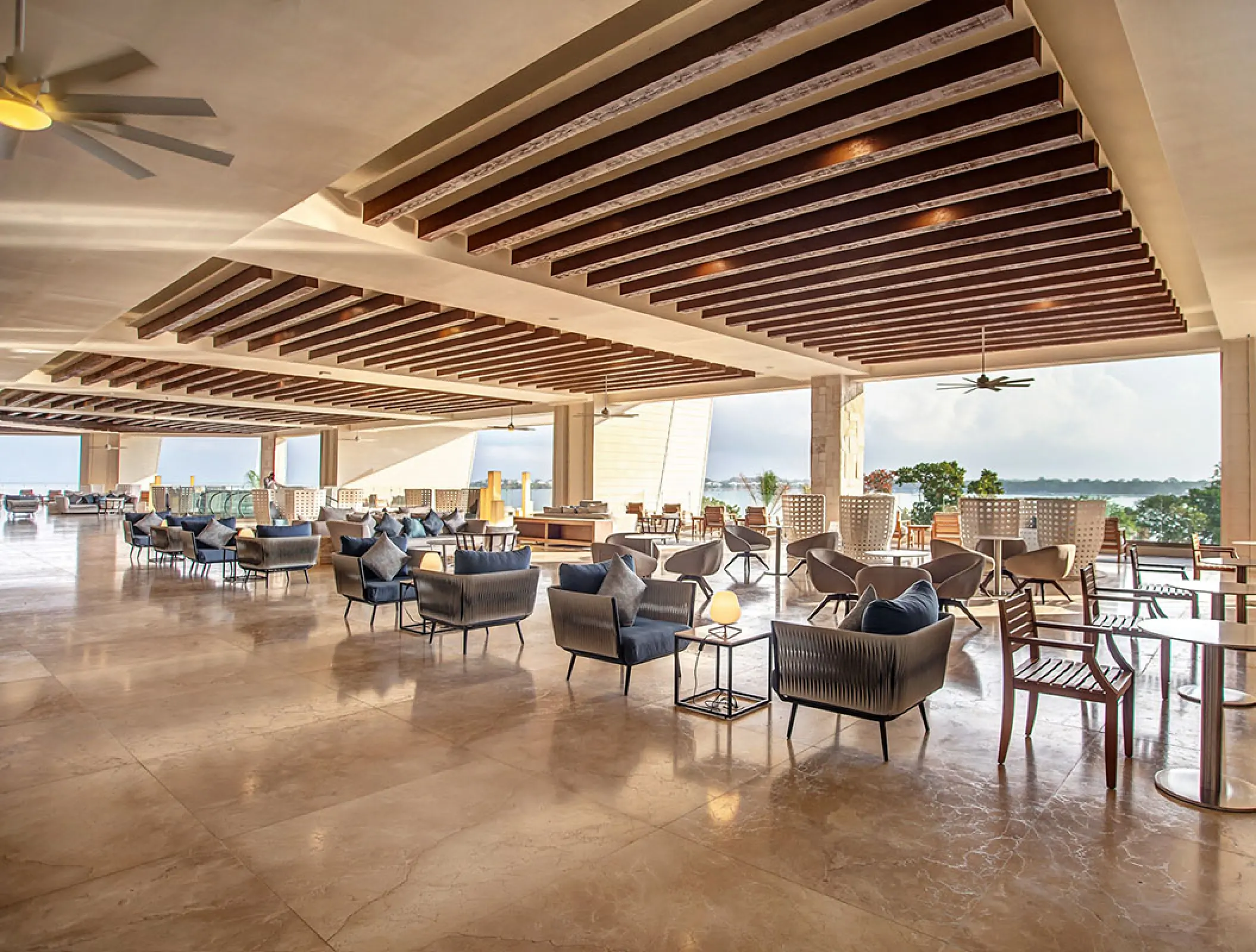 Open-air lobby lounge with modern seating at Royalton Negril, Jamaica
