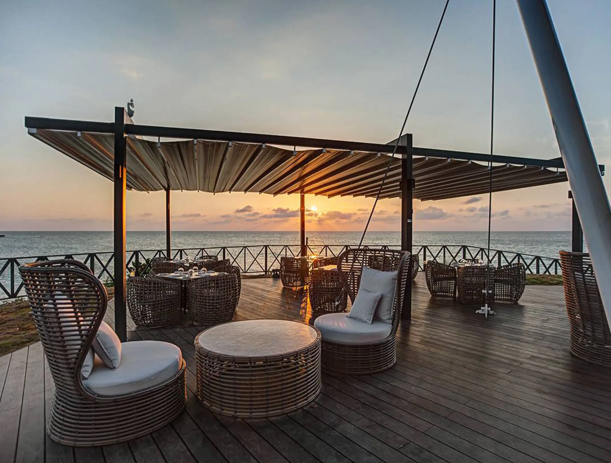 Ocean Point Lounge with wicker seating at sunset, Royalton Negril