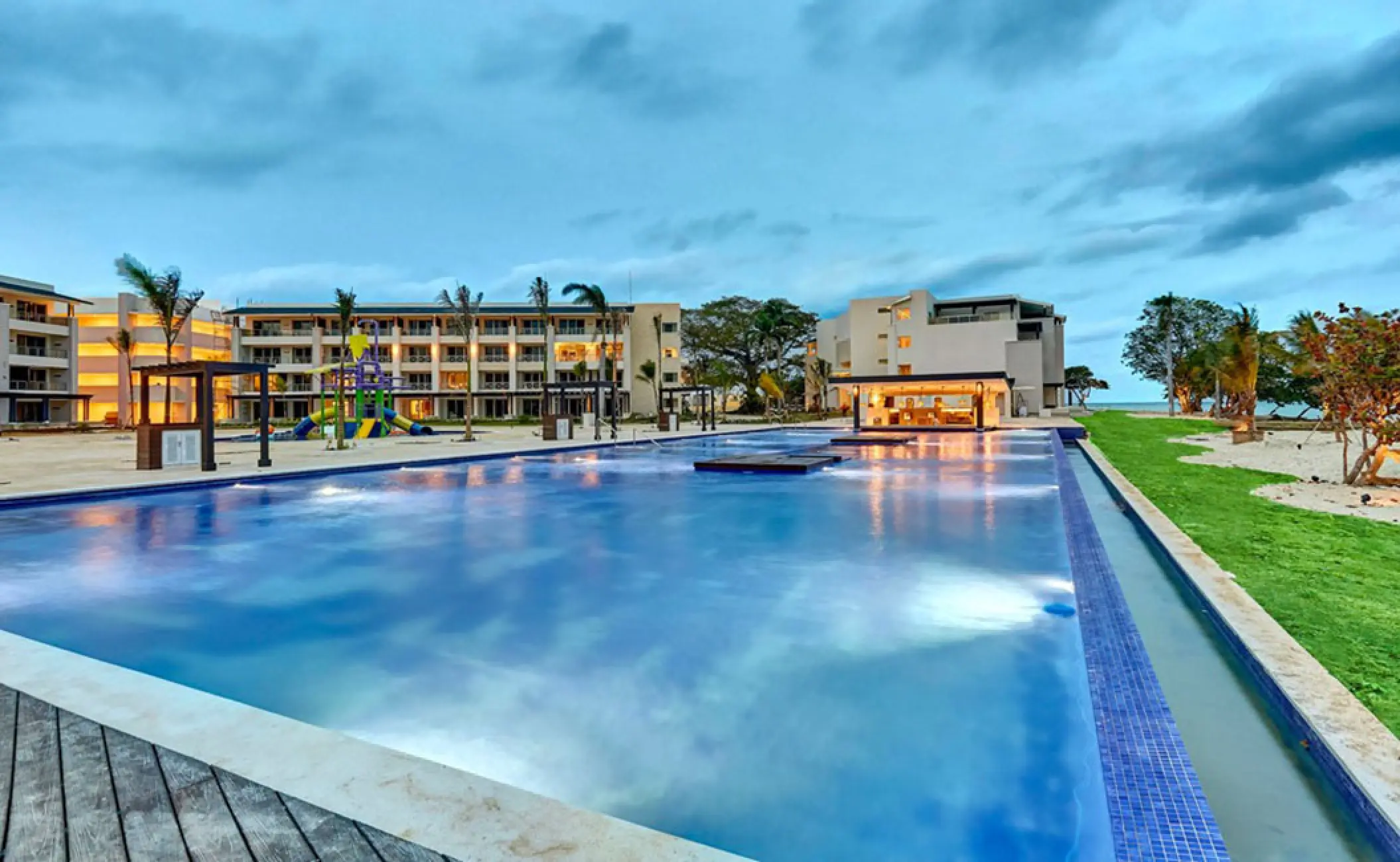Royalton Negril infinity pool at twilight with resort buildings in the background, Negril