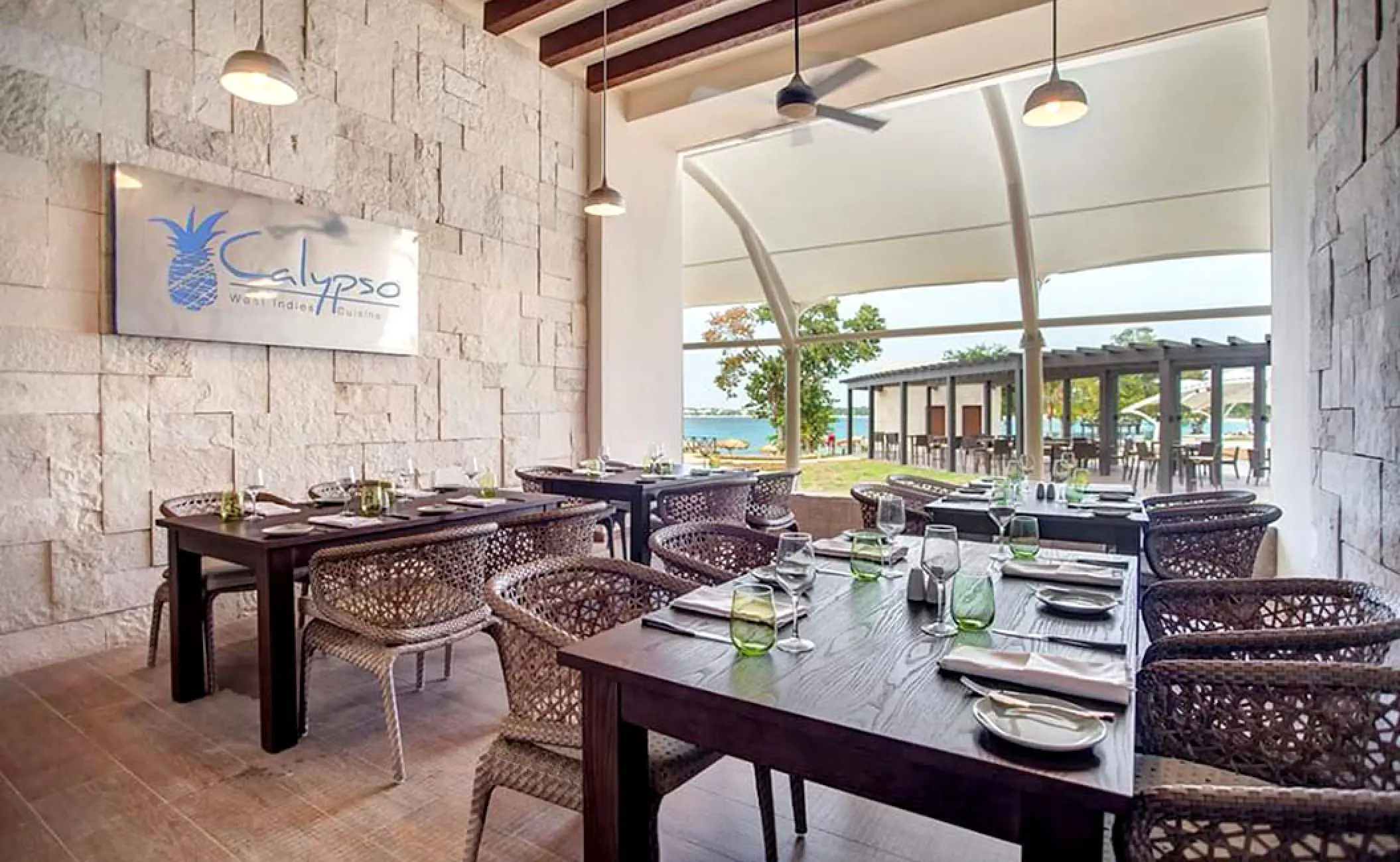 Calypso restaurant dining area with wicker chairs at Royalton Negril, Jamaica