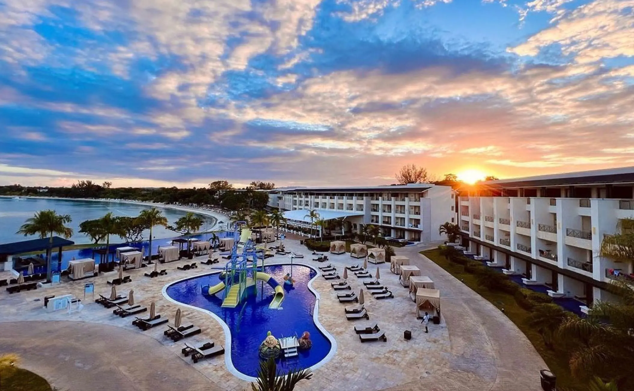 Royalton Negril grounds and pool with water slides at sunset, Negril