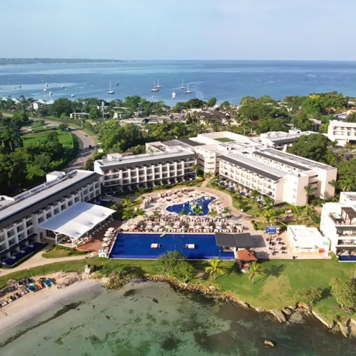 Aerial view of Royalton Negril buildings and pools along the coast, Negril