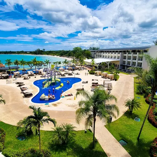 Aerial view of the splash park, resort grounds, and beachfront at Royalton Negril