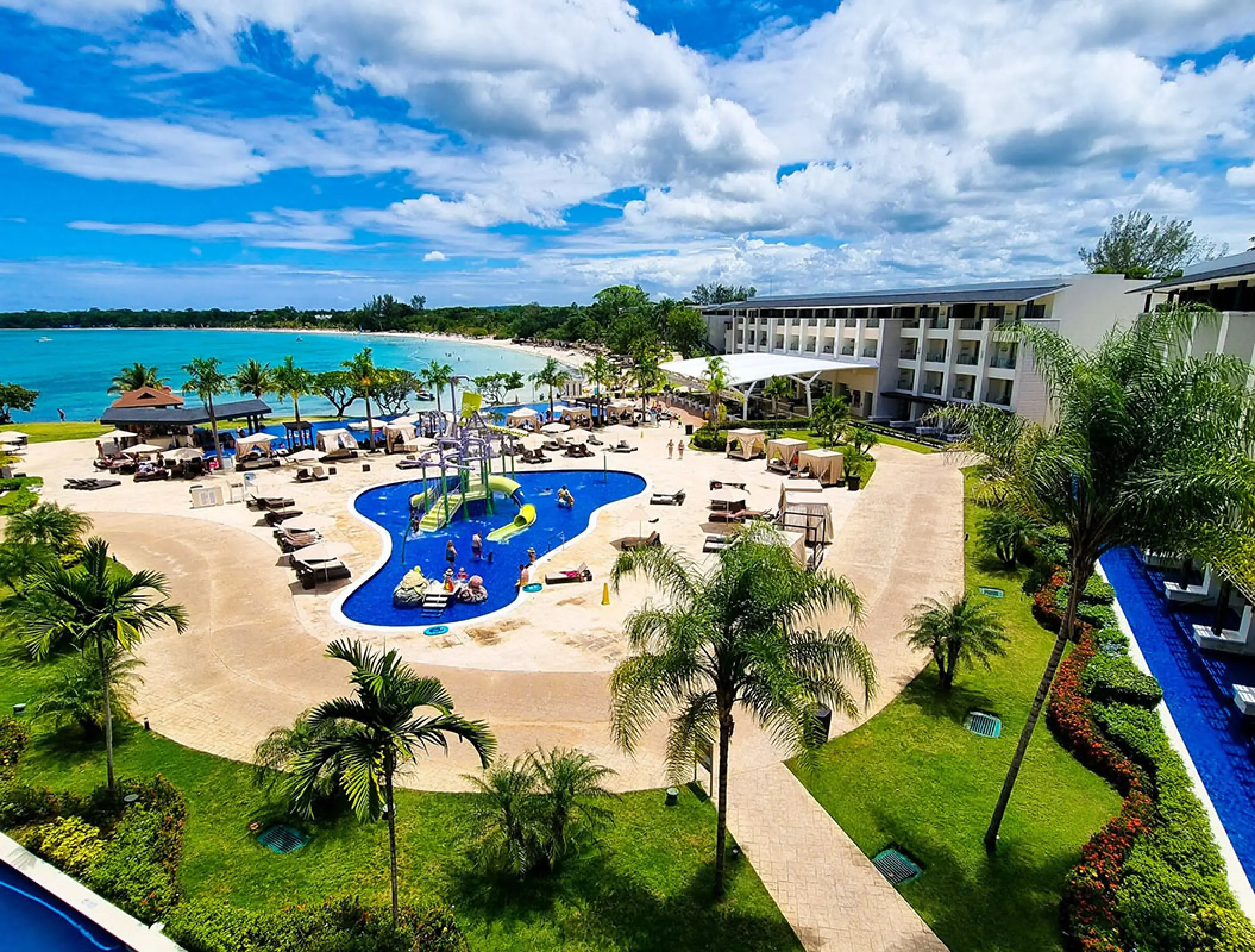 Aerial view of the splash park, resort grounds, and beachfront at Royalton Negril