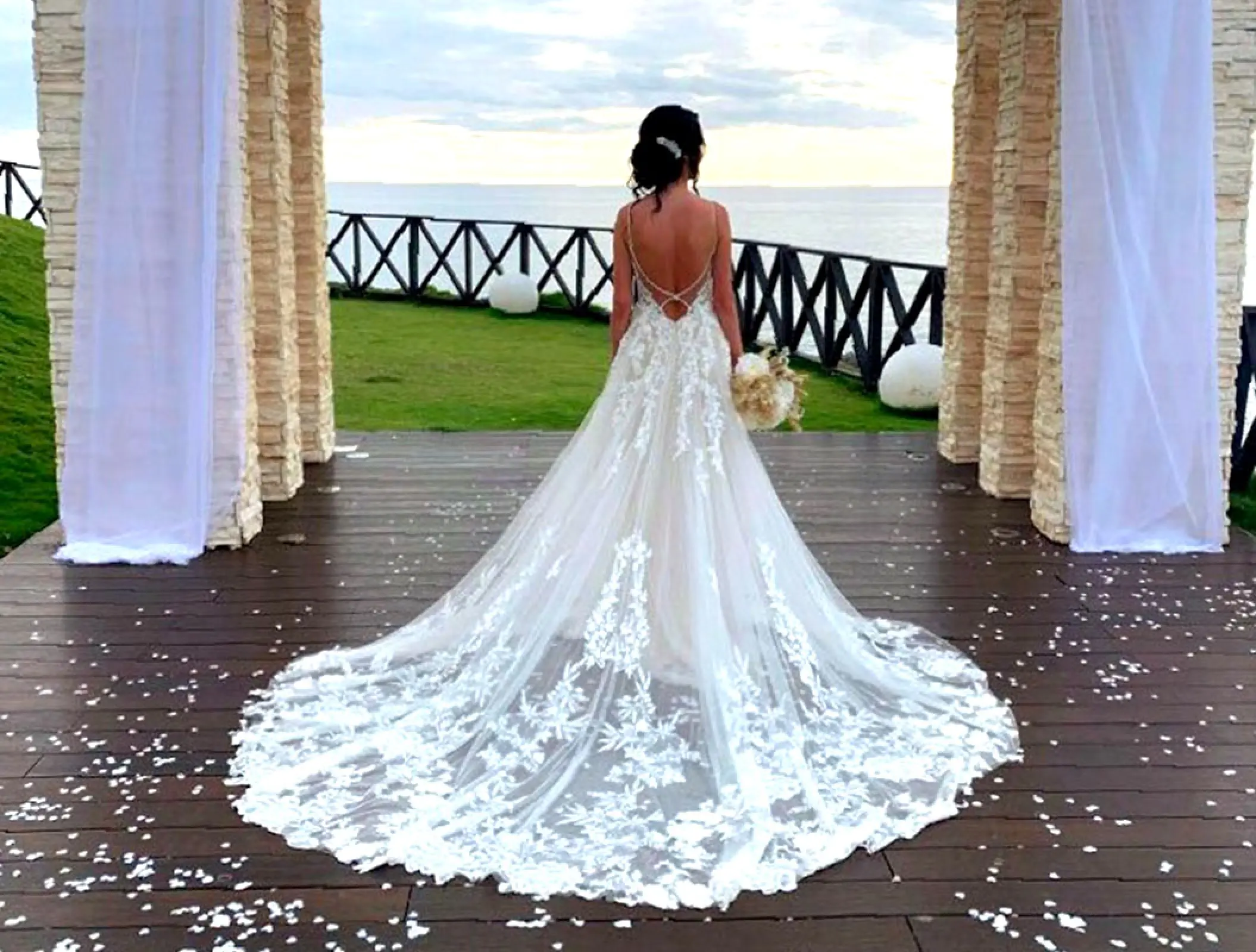 Bride in lace dress overlooking the ocean at Royalton Negril, Negril