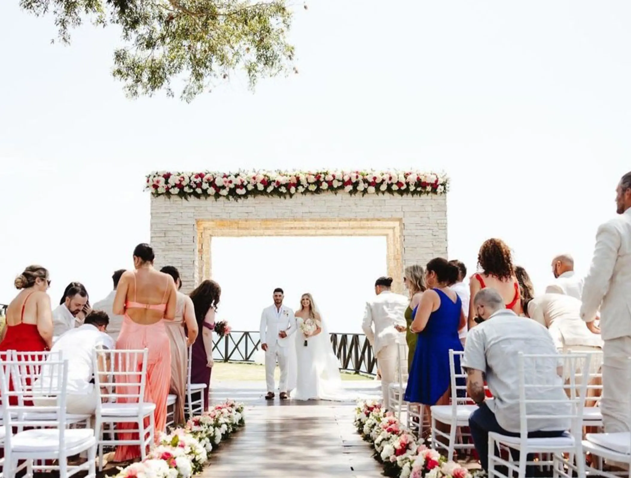 The bride and groom at the altar during a terrace wedding ceremony at Royalton Negril