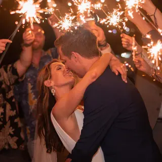 Newlyweds kissing during a sparkler send-off at Royalton Negril, Negril