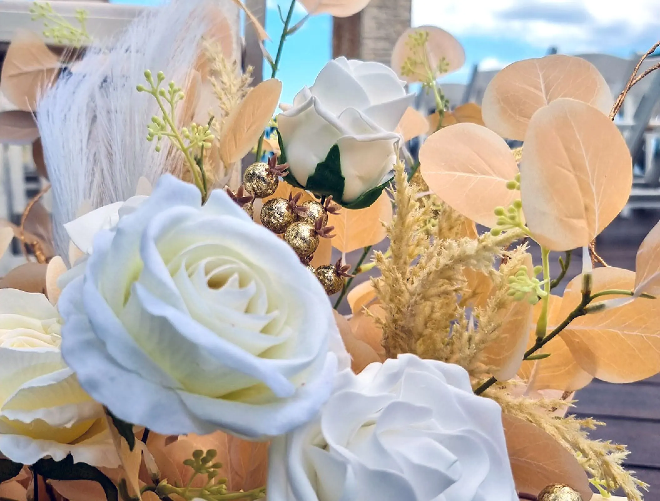 White roses and gold leaves wedding floral decor at Royalton Negril, Jamaica