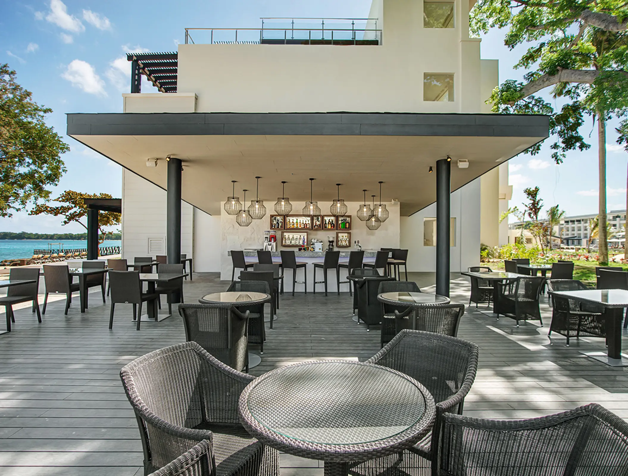 Outdoor patio bar and seating area at Royalton Negril, Jamaica
