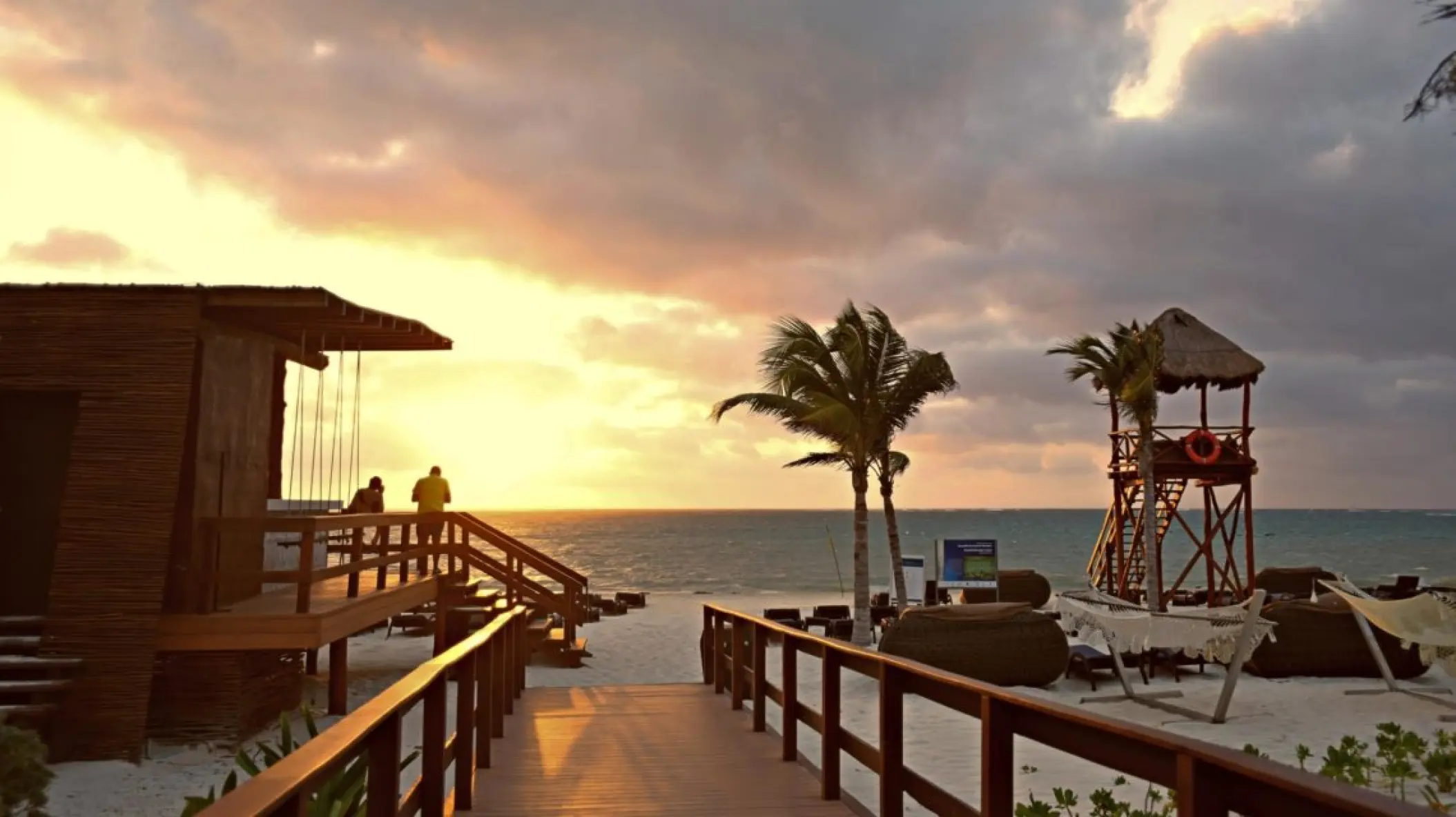 Wooden walkway leading to a beach sunset at Royalton Riviera Cancun