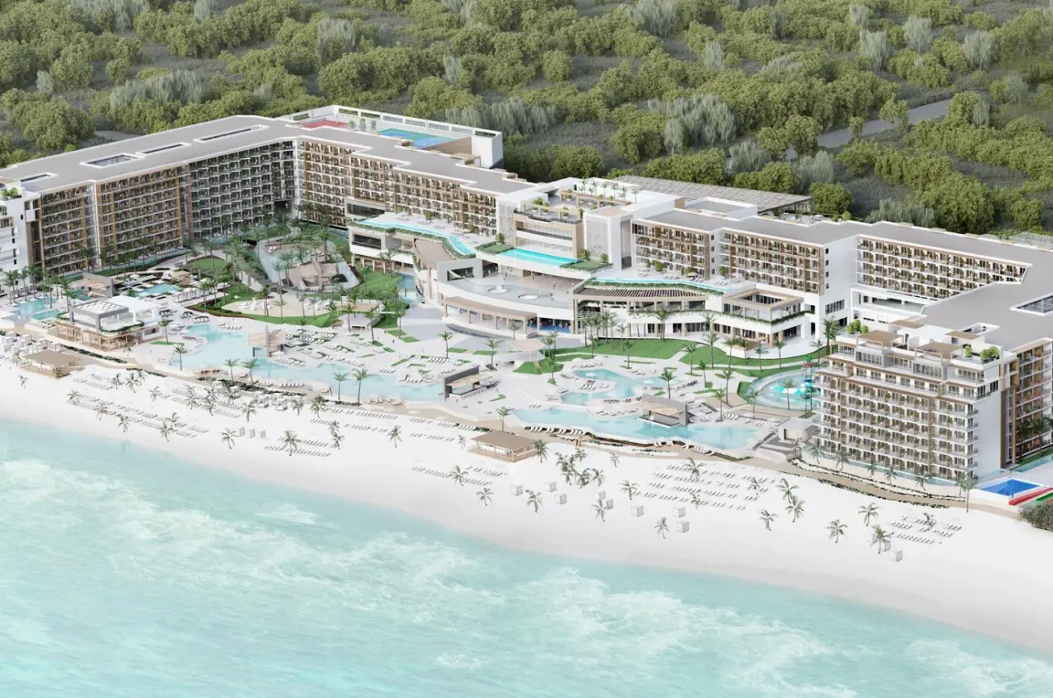 Aerial view of Royalton Splash Riviera Cancun buildings and pools along the white sand beach, Cancun