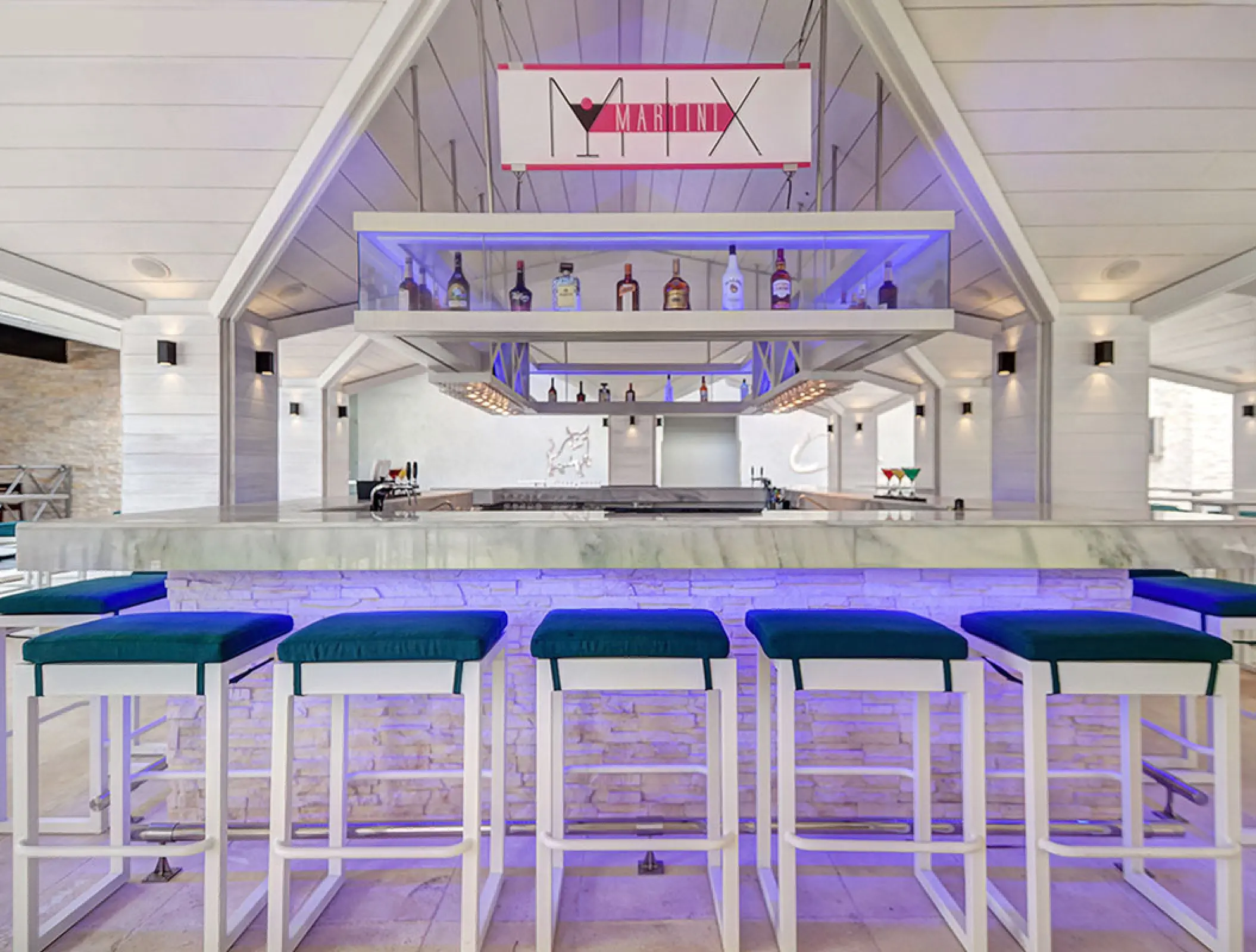 Martini Mix bar with blue under-counter lighting and bar stools at Royalton Blue Waters, Montego Bay