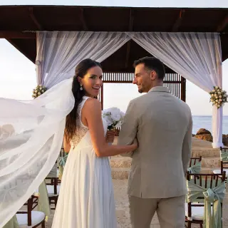 Bride and groom standing before a gazebo wedding ceremony at Royalton Blue Waters, Montego Bay