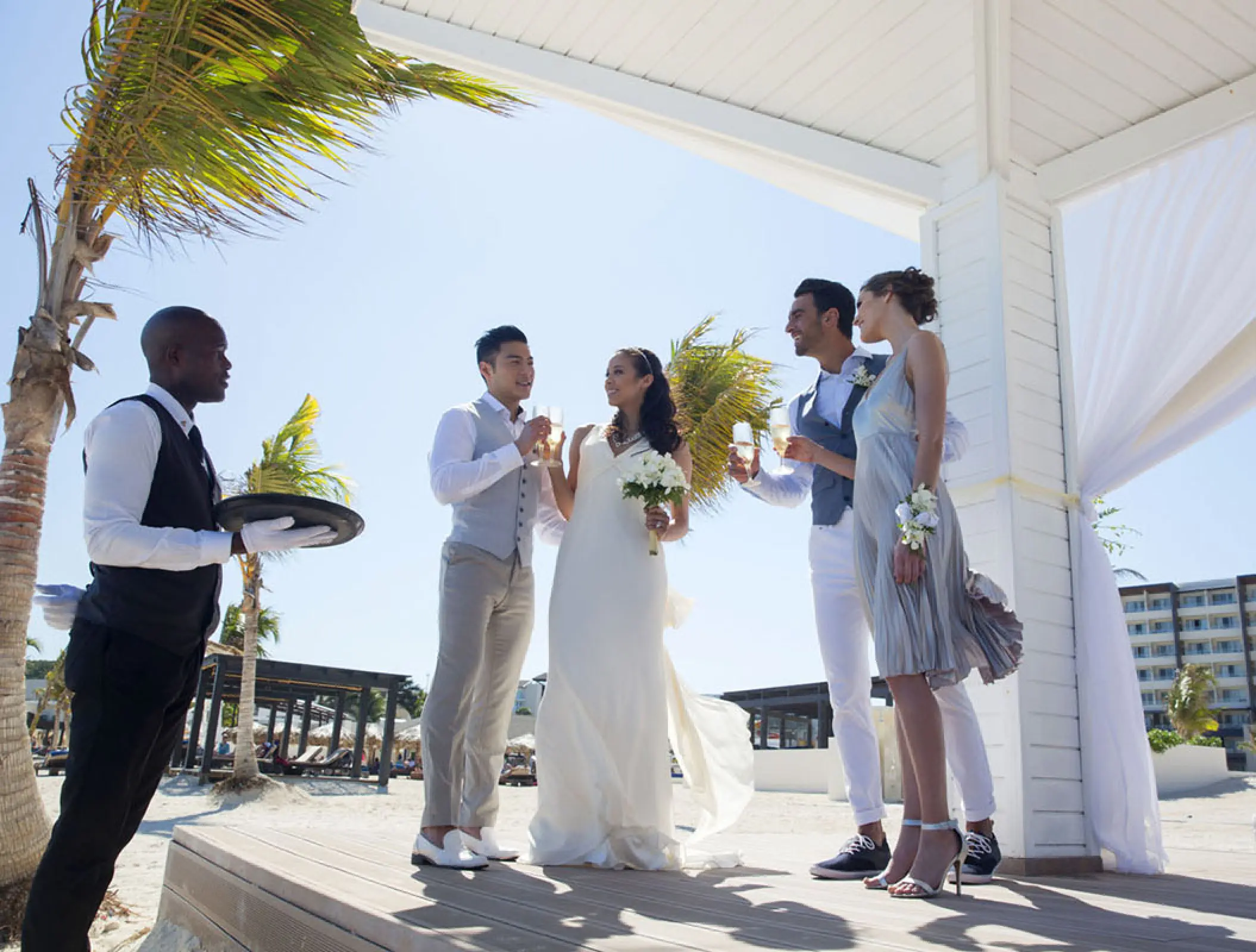 Bride and groom toasting with guests at Royalton Blue Waters, Montego Bay